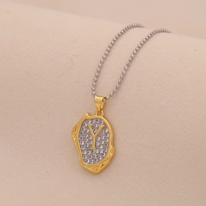 Close-up of two-tone beaded chain necklace with letter Y pendant and clear crystals