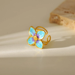 Adjustable gold plated stainless steel ring with blue and purple enamel flower petals