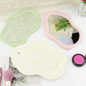 Cloud-shaped makeup mirrors in pastel green, pink and beige with folding stand