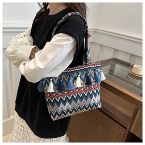 Ethnic canvas tote bag with colorful chevron patterns and tassel charms on shoulder strap