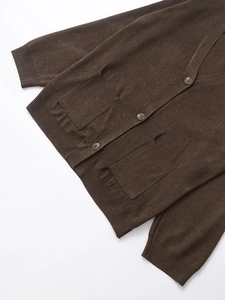 Detail of dark brown V-neck cardigan featuring marble buttons and fine ribbed knit texture