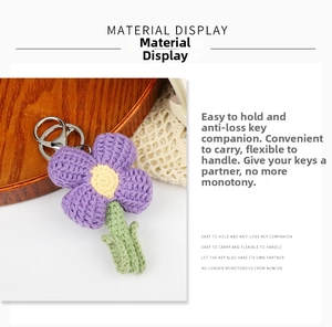 Close-up of handmade crochet flower keychain with purple petals and silver lobster clasp