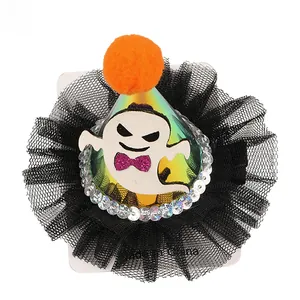 Close-up of Halloween ghost hair clip with black tulle, orange pompom and silver sequins
