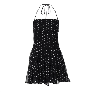 Detail of black polka dot halter neck dress with adjustable neckline tie strings