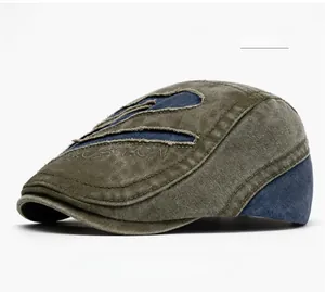 Detail of vintage military green washed cotton newsboy cap with Boston embroidery