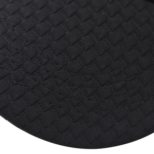 Detail of baseball cap brim showing black checkered textured fabric and curved stitching