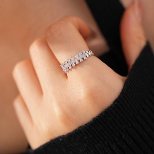 Detailed view of silver open ring with staggered rectangular zircon floral stones