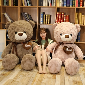Giant plush teddy bear with love heart embroidery and bow tie shown with model