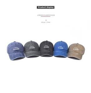 Detailed row of washed cotton baseball caps with outdoor mountain embroidery in five colors
