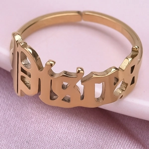 Macro shot of gold-plated 304 stainless steel open ring with gothic Bitch engraving