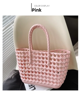 Detailed view of pink woven hollow-out jelly basket bag with integrated handle