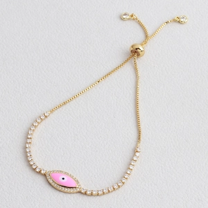 Detail of pink evil eye bracelet in gold finish with slider clasp and sparkling zircons