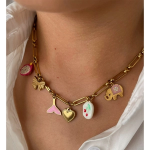Golden multi-pendant necklace with butterfly, fish tail and heart on chunky chain