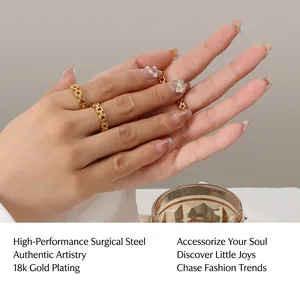 Detail of 18k gold plated titanium steel cuban link rings with rhinestone butterfly charm