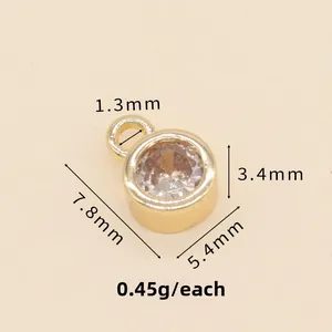 Detailed macro view showing 5.4mm round 14k gold pendant dimensions and zircon inlay