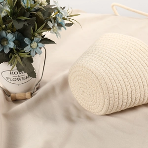 Close-up of beige handwoven cotton rope bag showing detailed spiral texture and soft fabric