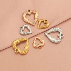 Polished stainless steel heart wing charms in gold, rose gold and silver finishes