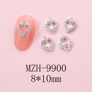 Macro view of 8x10mm hollow heart nail charms with silver alloy and sparkling rhinestones