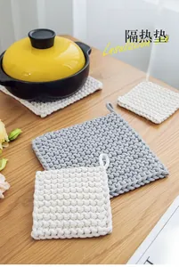 Detail showing thick woven cotton rope placemats in cream and grey with hanging loops
