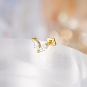 Close-up of golden marquise cubic zirconia cartilage stud with flat back screw threading