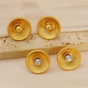 Detailed view of vintage gold-plated titanium steel earrings with zircon and silk background