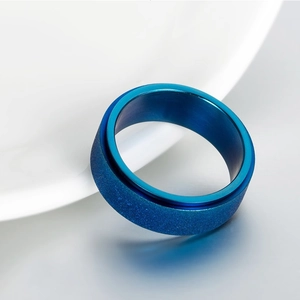 Blue frosted stainless steel spinner ring with inner polished surface for stress relief