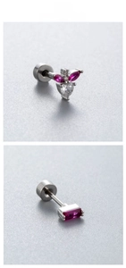 Detailed tile display of silver steel earrings with heart and purple zircon pendants