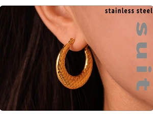 Detail of 18k gold plated stainless steel hoop earring with snake skin texture on model