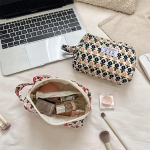 Floral corduroy cosmetic bag detail showing large storage capacity for beauty products