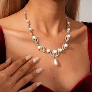 Elegant two-piece sweater necklace featuring waterdrop pearls and diamond leaf accents