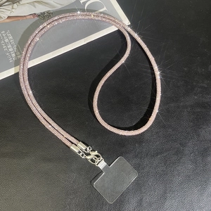 Detailed view of luxury pink rhinestone phone wristlet strap with silver metal lobster clasp