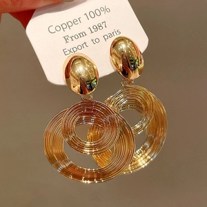 Detail of tiered gold circular earrings in 100% copper with a polished vintage finish