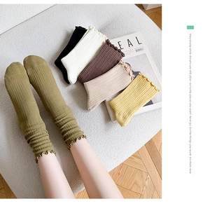 Detailed view of women's ribbed cotton socks with ruffled cuffs in six earthy colors