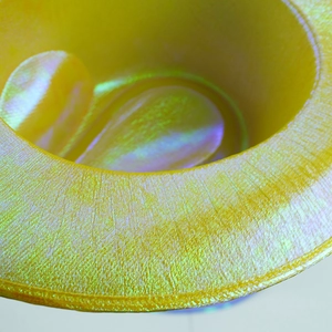 Macro detail of the iridescent yellow laser finish and texture on the western cowboy hat