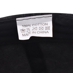 Detail shot of the internal 100% cotton wash label and fabric stitching on a baseball cap