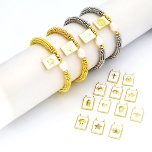 Bohemian style pearl beaded bracelet set with gold and silver enamel charms and pendants