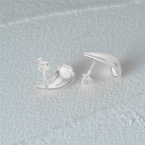 Macro detail of S925 sterling silver stamp on minimalist C-shape star stud earrings