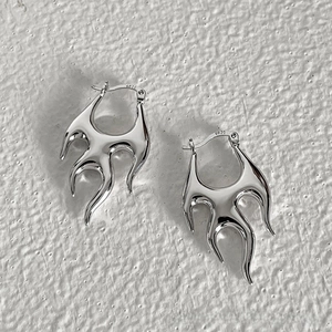 Detail shot of punk lava earrings showing S925 silver hallmark on polished metal