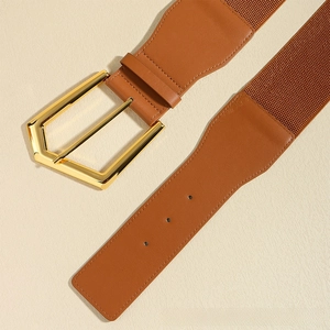 Close-up of brown elastic wide belt with golden geometric buckle and leather stitching