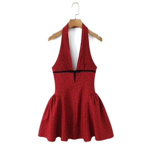 Red halter neck dress with black polka dots and a waist-slimming bow-knot detail