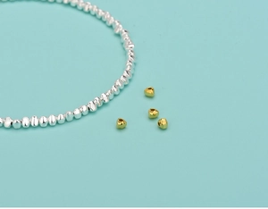 S925 silver irregular beads and gold heart spacers on a light blue background