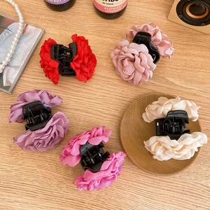 French vintage rose hair claws in five colors arranged on a wooden table setup