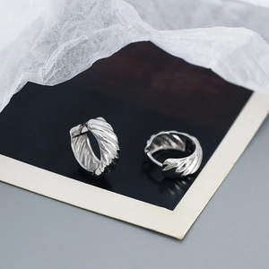 Close-up of S925 sterling silver twisted hoop earrings with a polished metallic finish