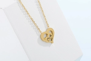 Detailed view of golden double-layer hollow heart MOM pendant necklace on white display