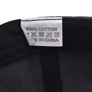 Detail view of the 100% cotton wash label and fabric texture on a vintage NY baseball cap