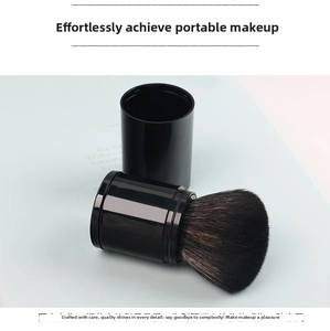 Macro detail of portable black retractable makeup brush with dense soft bristles and cap