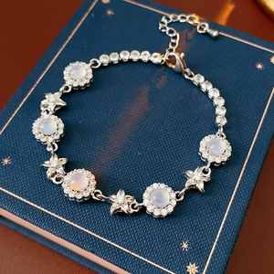 Detail of silver bracelet with zircon chalcedony flowers on a luxury jewelry box