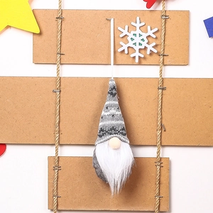 Close-up of a knitted Christmas gnome ornament with white beard on a rustic wooden background