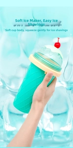 Close-up of squeezing mint green silicone slushy cup with cherry lid for quick ice making