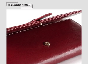 Macro shot of high-grade golden button closure and oil wax leather texture on wine red wallet